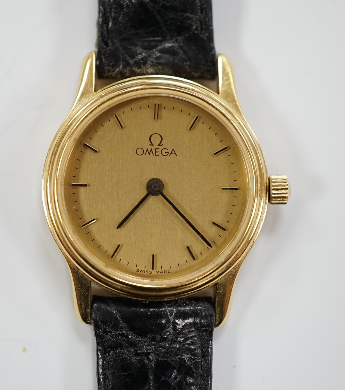 A lady's 18ct gold Omega quartz wrist watch, with case back inscription, on a leather strap with Omega buckle, with Omega box.